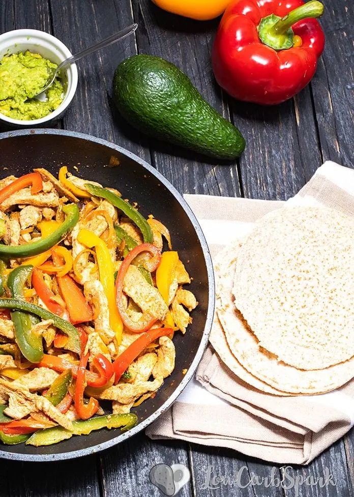 These Easy Chicken Fajitas are healthy, quick to make and perfect for a weeknight dinner. The chicken is succulent, super flavourful and the low carb tortillas are fantastic. Enjoy this one-pan meal made with peppers, onions, chicken spicy fajita seasoning. 
