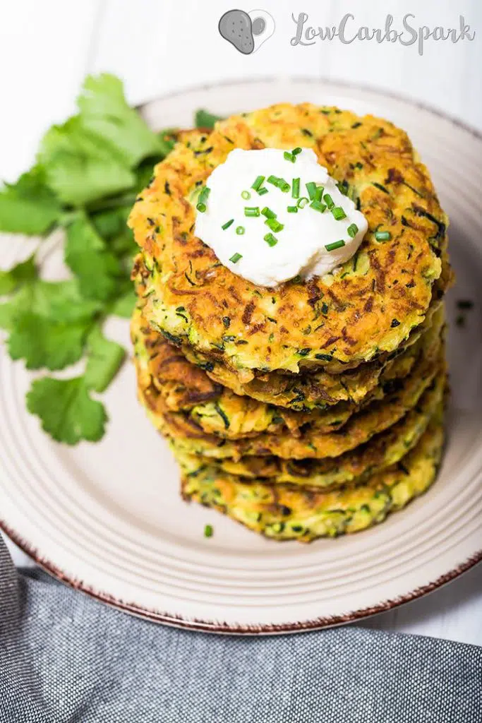 Zucchni Fritters topped with a dollop of sour cream and chives