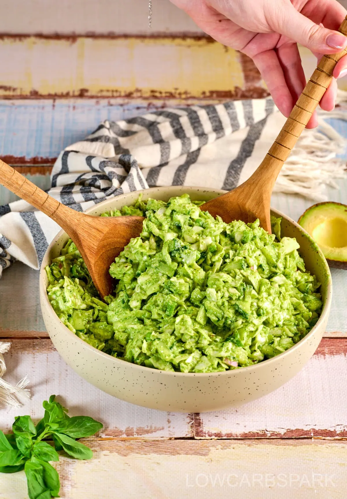 Tik Tok Green Goddess Salad in a bowl with serving spoons showing texture