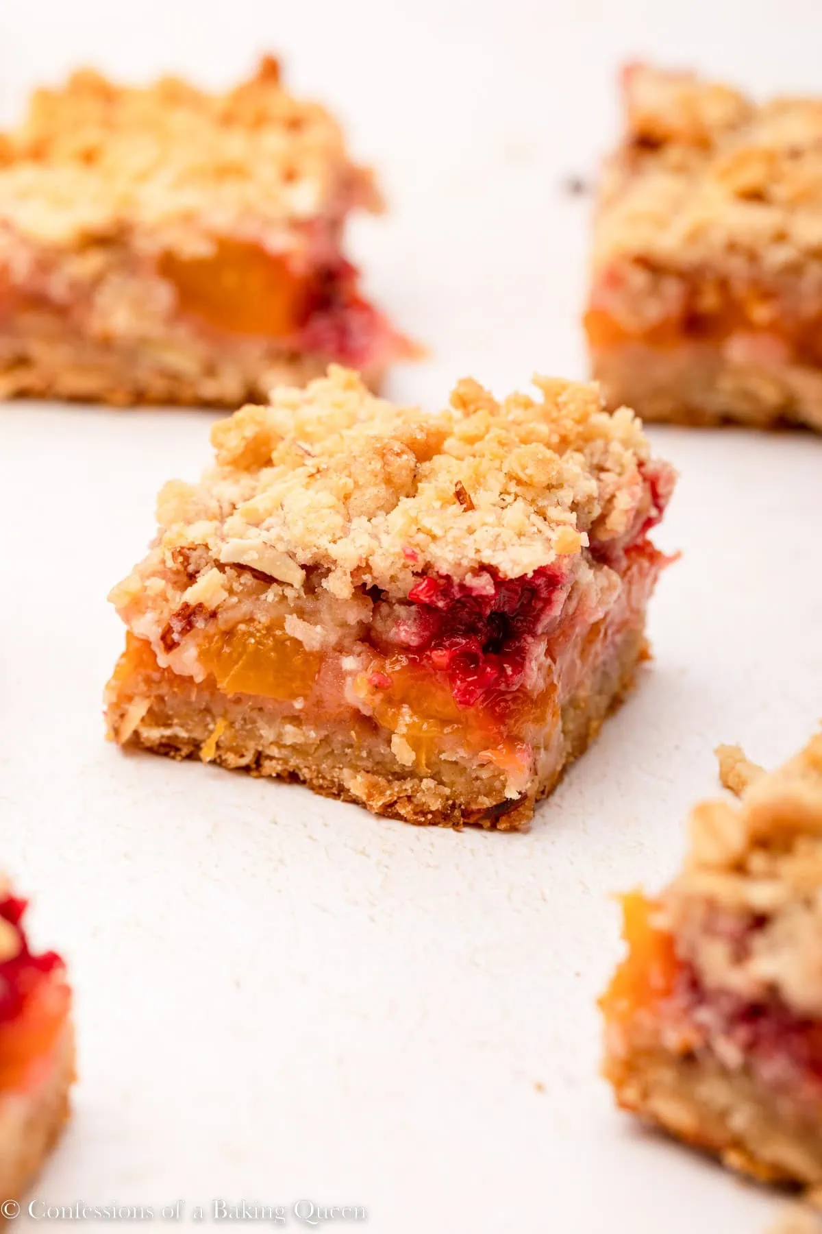 peach raspberry crumb bars on a light surface 1 of 1